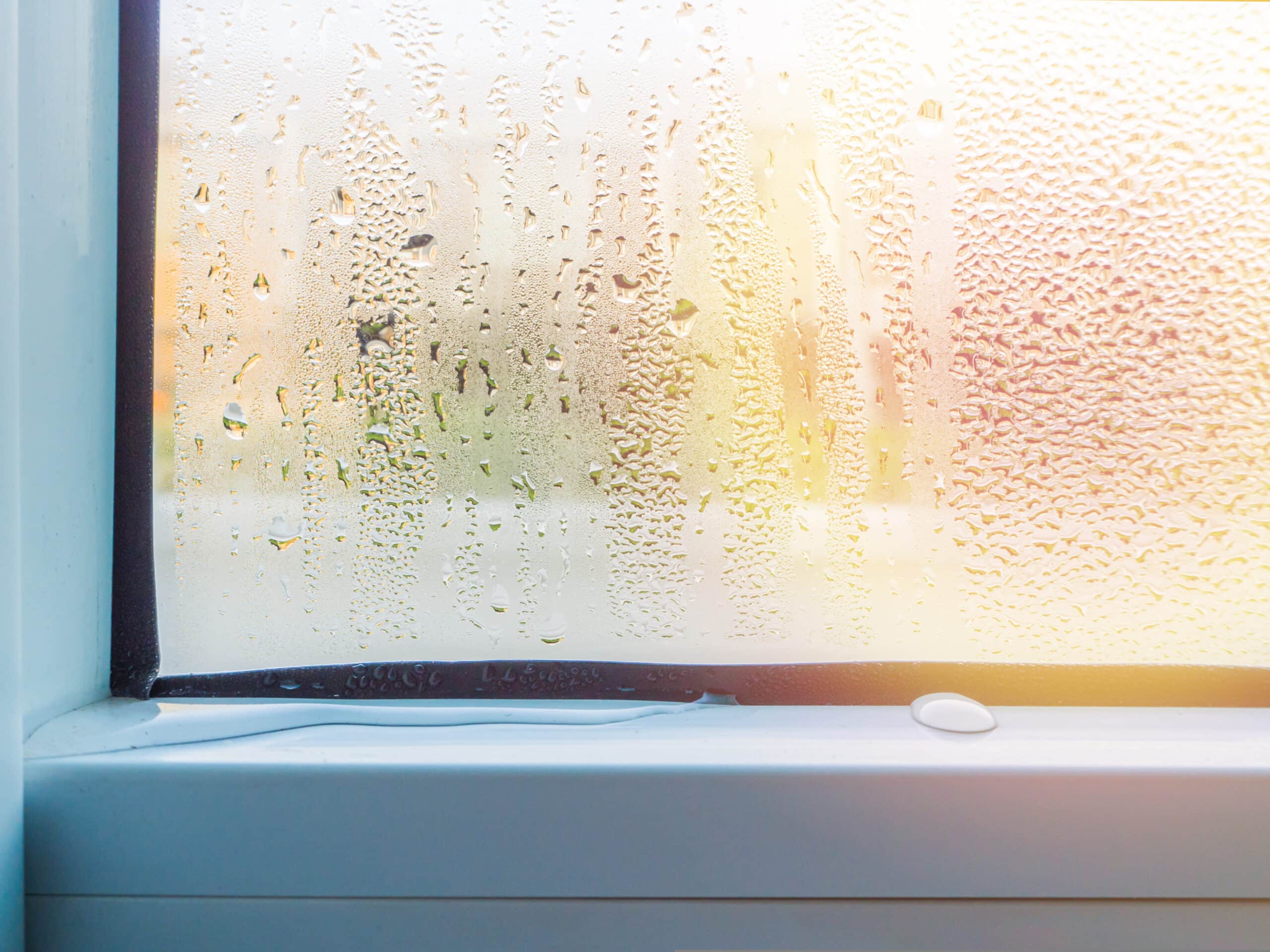 In the morning sunshine, see the view through the glass window which have the water drop, the atmosphere is so refreshing.